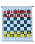 Demonstration chess set roll-up board with red and yellow magnetic pieces hung on wall