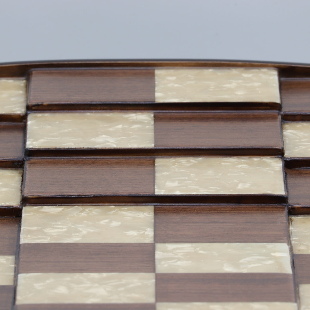 Super close up view showing different 3D square levels of solid beech wood 3D Chess Board with walnut and mother of pearl inlays with pyramid-style design and 50mm squares.