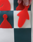 Demonstration chess set stick-in pieces being inserted into pocket