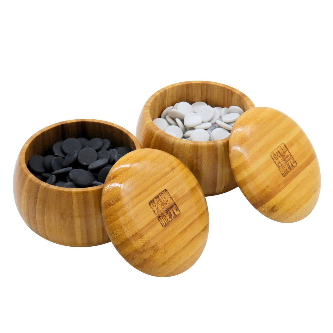 Go Bowls &amp; Stones Set with lids lifted off 2 bamboo bowls showing black and white ceramic go stones