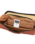 Open faux leather zip bag with carry handle for luxury Rummikub set by Helena Wood Art showing racks and tiles in protective velvet pouches.