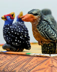 Close up of African Bird Noughts & Crosses resin game set with hand-painted birds showcasing Kingfisher & Guineafowl pieces